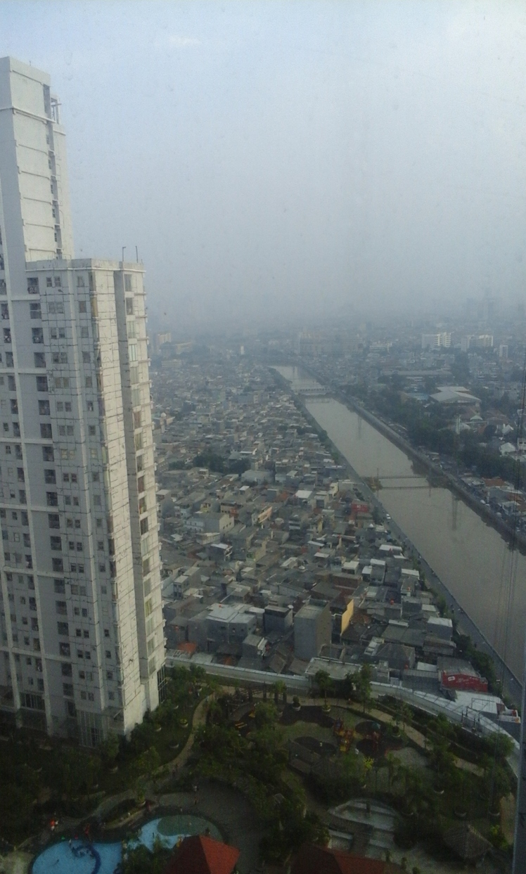 An unfiltered image of Jakarta from the window in the elevator bank of our apartment building. That is smog, not rain.