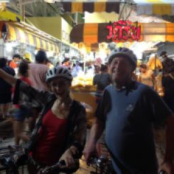 Dad and I riding our bikes through the evening flower market in old Bangkok.